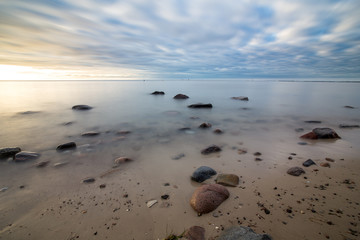  Sunrise over the sea. Beautiful long exposure landscape of rocky shore