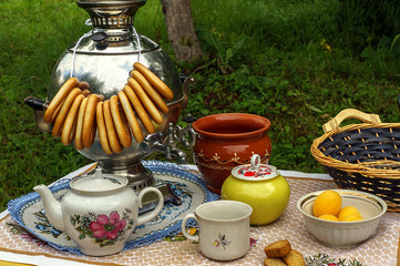 Russian tableful with samovar in the garden