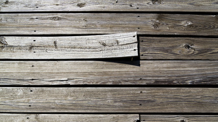 background of weathered boards with one warped