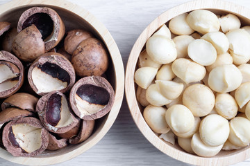 Top view macadamia nuts and shell in wooden bowl