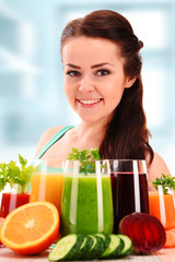 Young woman with variety of vegetable and fruit juices