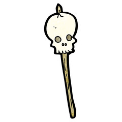 cartoon skull on spike
