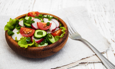 Spring salad with tomato, cucumbers and radish