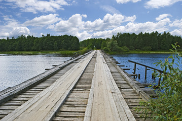 Old wooden bridge over the river, Russia