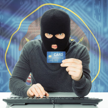 Hacker holding credit card and USA state flag - Utah