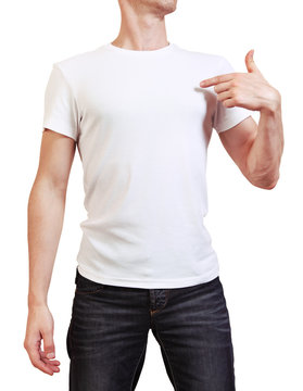 Image of young man in white t-shirt pointing on blank copyspace