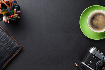 Office desk table with coffee cup, camera and supplies