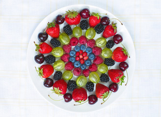 Various ripe berries on the round plate