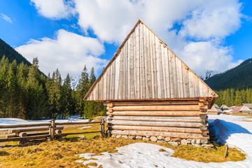 Old wooden mountain hut in Chocholowska valley in spring season, Tatra Mountains, Poland