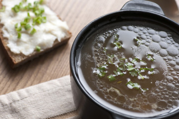 Mushroom soup served with lard spread with green onion