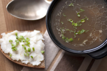 Mushroom soup served with lard spread with green onion