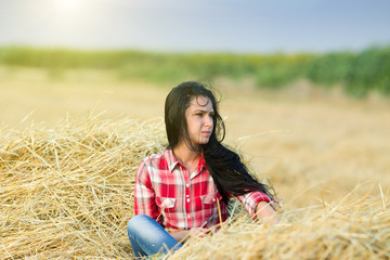 Wind blowing girl's long hair in the field