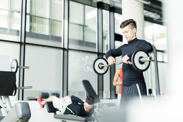 Fototapeta premium Young man training in a gym