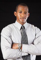 Thoughtful businessman with arms crossed