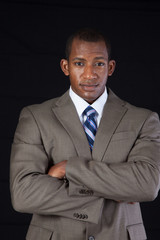 Thoughtful businessman with arms crossed