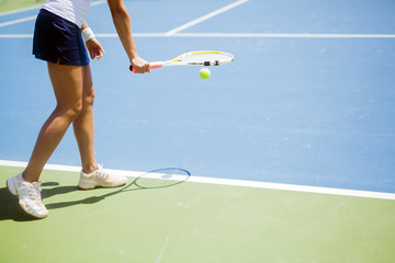 Beautiful female tennis player serving