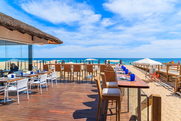 Terrace of a restaurant on Armacao de Pera beach in Algarve region, Portugal