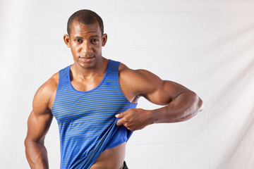 Black man lifting his shirt to show his abdomen