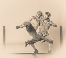 couple of young man and woman dancing hip-hop