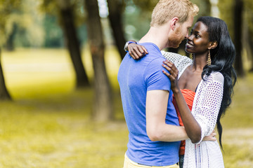 Fototapeta premium Couple in love hugging and kissing peacfully outdoors