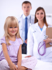 Fototapeta premium Female doctor examining child with stethoscope at surgery