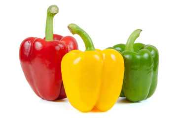 Three colored peppers on white background