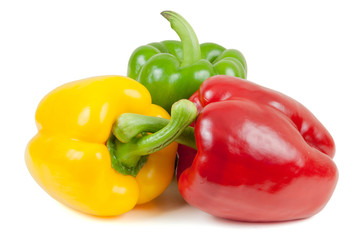 Three colored peppers on white background