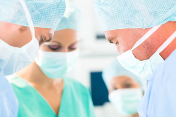 Surgeons operating in operation theater room