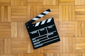 Movie clapper board on wooden floor