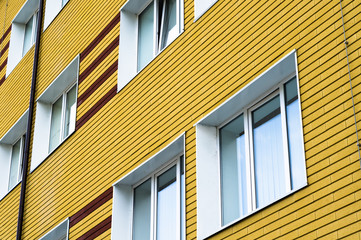 Many windows in yellow brick building
