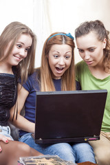 Friendship Concepts: Three Surprised  Caucasian Girls With Lapto