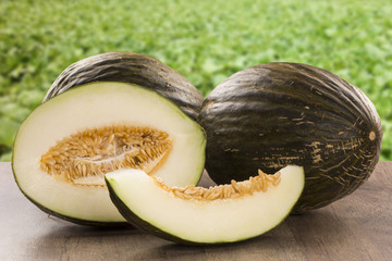 Some melons over a wooden surface