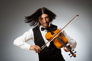 Man playing violin in musical concept