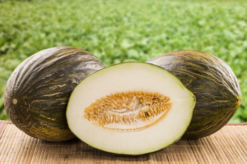 Some melons over a wooden surface