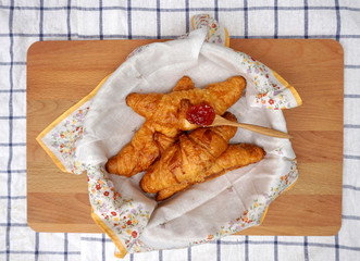 Croissants in the basket with flower pattern napkin