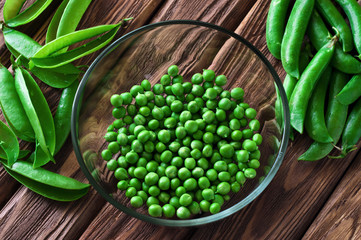 fresh green peas peeled in a glass bowl