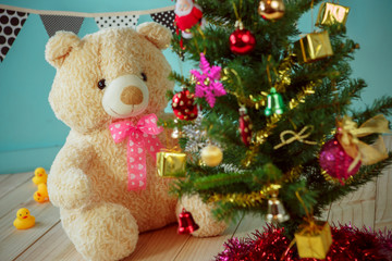 Bear with christmas tree on green background