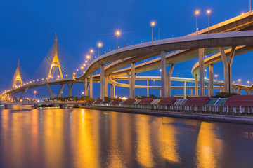 Fototapeta na wymiar Twilight at Suspension bridge and highway curved with clear blue sky, Bangkok Thailand
