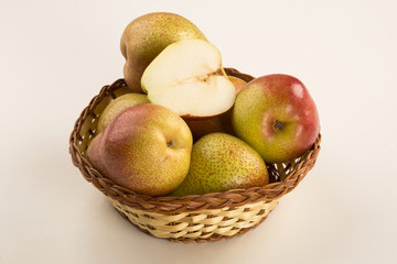 Some pears in a basket over a wooden surface seen from above