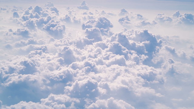 Aerial view cloudscape shot from aircraft in very steady slow motion.