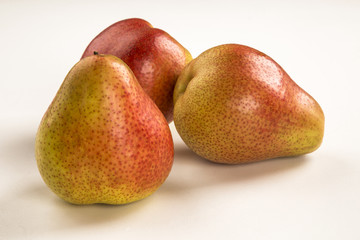 Some pears in a basket over a wooden surface seen from above