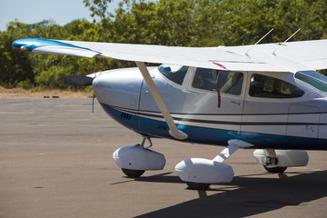 Small airplane parked with forest behind, Canaima, venezuela
