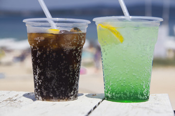 coke and mint with soda on a white wood table on the beach.Concept: Holiday,alcohol,summer