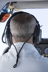 Pilot wearing uniform with epaulettes during take-off in small p