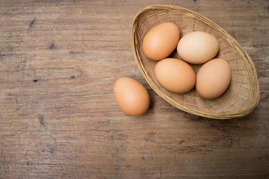 Eggs basket on wooden background