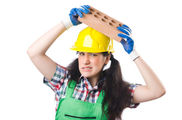 Female workman in green overalls holding brick isolated on white