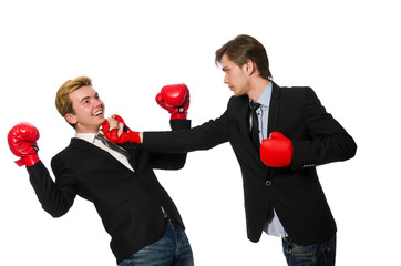 Pair of businessmen boxing on white