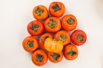 Some khaki fruits over a wooden surface