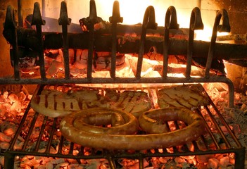 grilled meat with sausage and pork chop in the fireplace with th