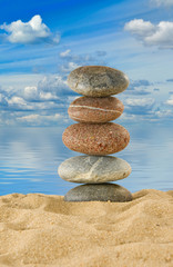 stones in the sand against the water